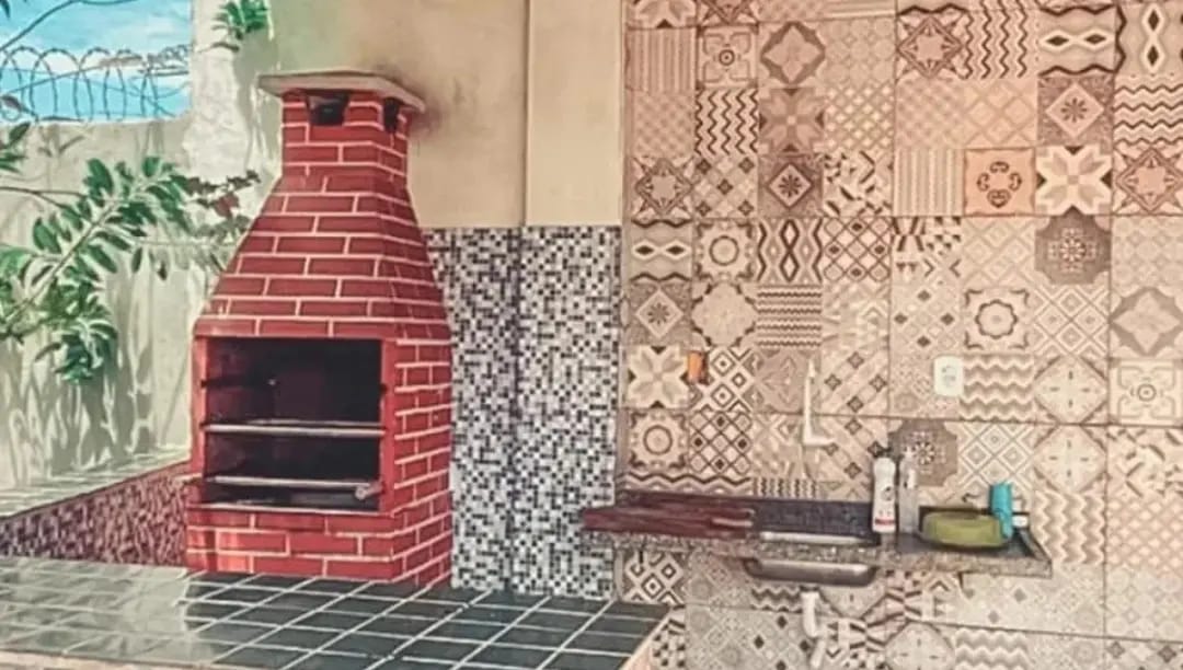 Área gourmet com churrasqueira de tijolos