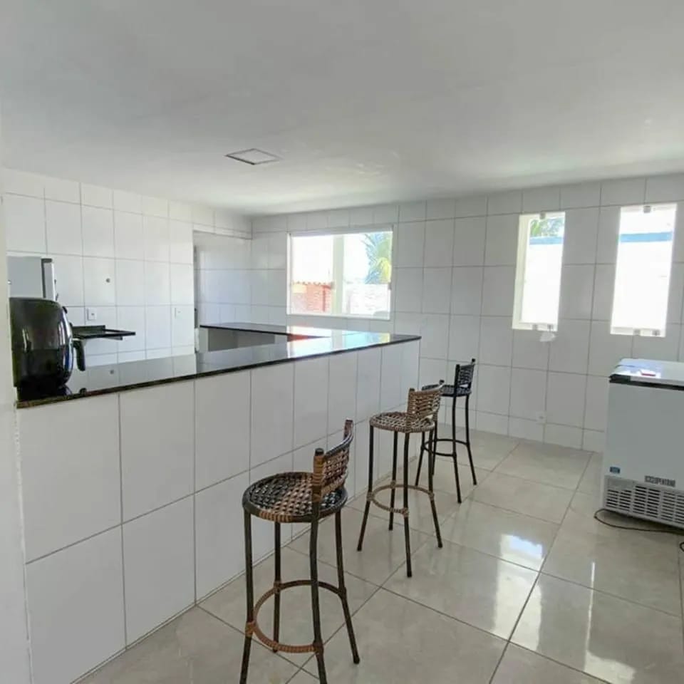 Cozinha ampla com bar e banquetas